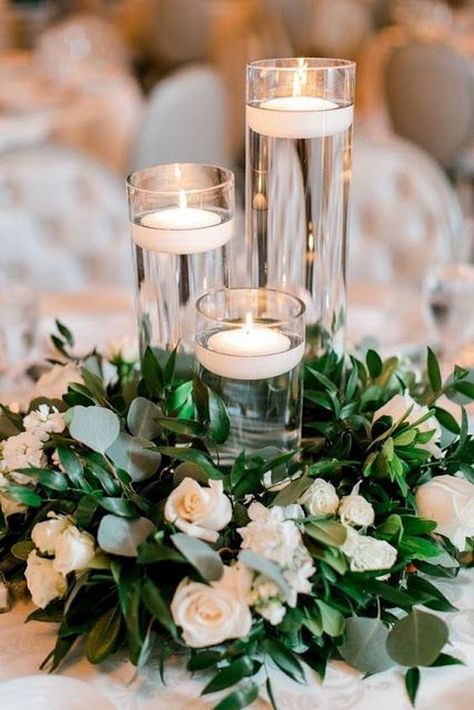 floating candles with greenery and flowers